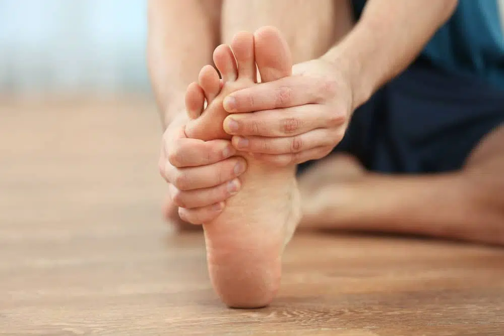 Man is suffering from severe foot pain Weakness and Instability