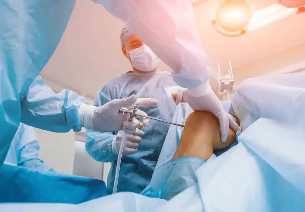 Surgeon is doing some Knee Arthroscopy surgery to the patients knee