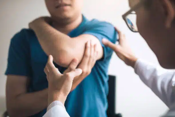 Surgeon doing some physical examination to the patient with a shoulder injury 