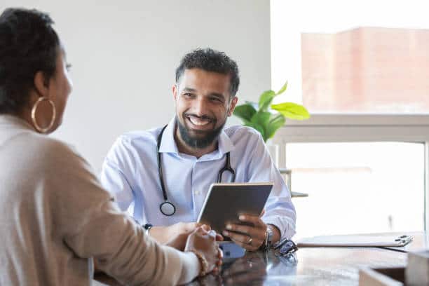 Surgeon having a consultation with a patient in a surgery center 