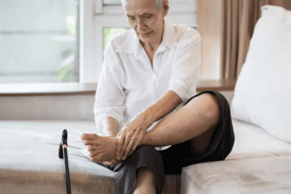 Senior woman suffers from tarsal tunnel syndrome.