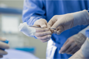 Surgeons performing a surgery inside the operating room.