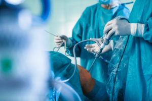 Surgeons performing knee surgery to the patient inside the operating room.