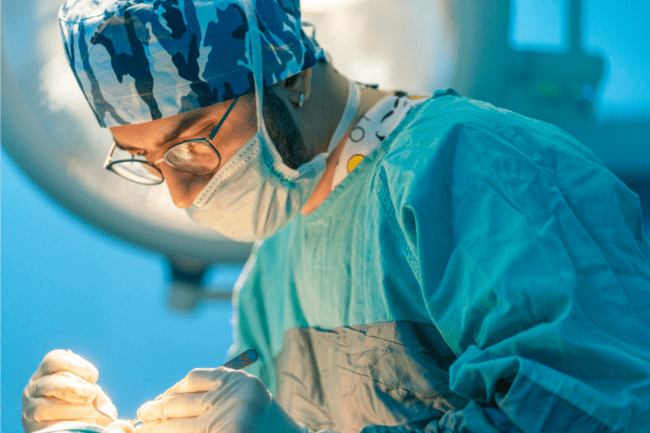 Orthopedic surgeon doing some Elbow Bursectomy surgery to the patient inside the operating room.