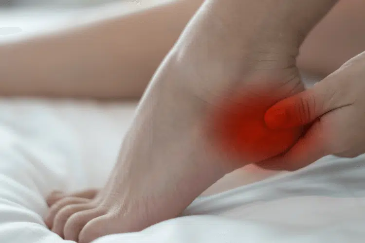 Woman suffers from Achilles heel pain.