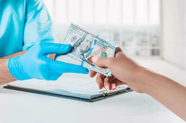 Patient paying cash payment for his surgery.