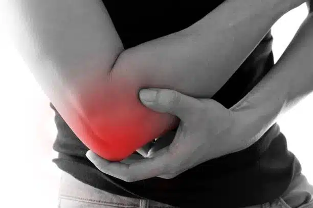 Man suffers from Bursitis feeling of intense pain on his elbow.
