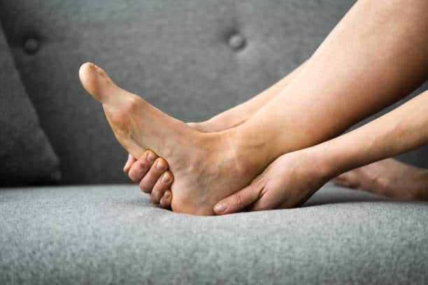 Woman Feeling Achilles Heel Pain In Bed