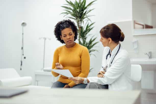 Female patient and doctor discussing about the price transparency of cash payment in their facility.