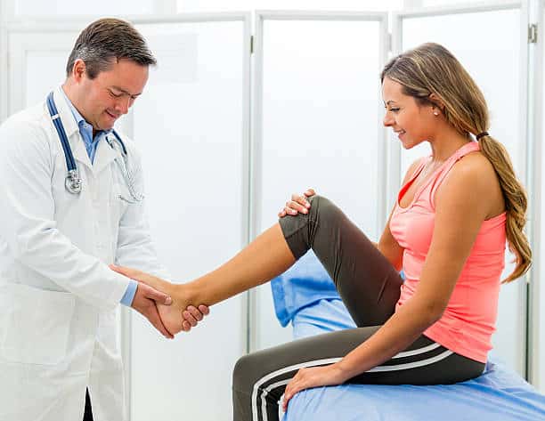 Woman with sprained ankle having her check up at the surgery center.