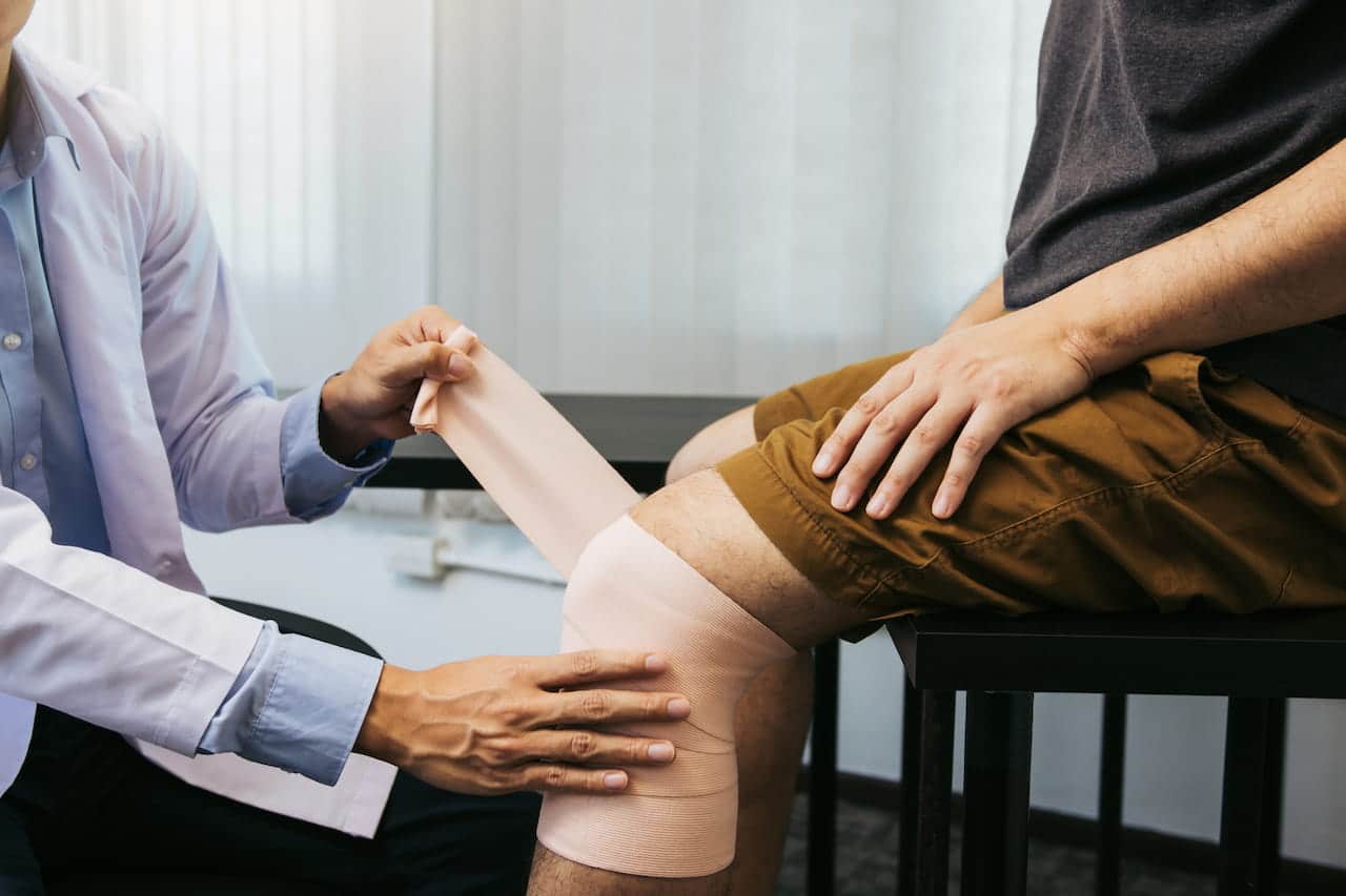 Surgeon checking a patients knee after surgery.