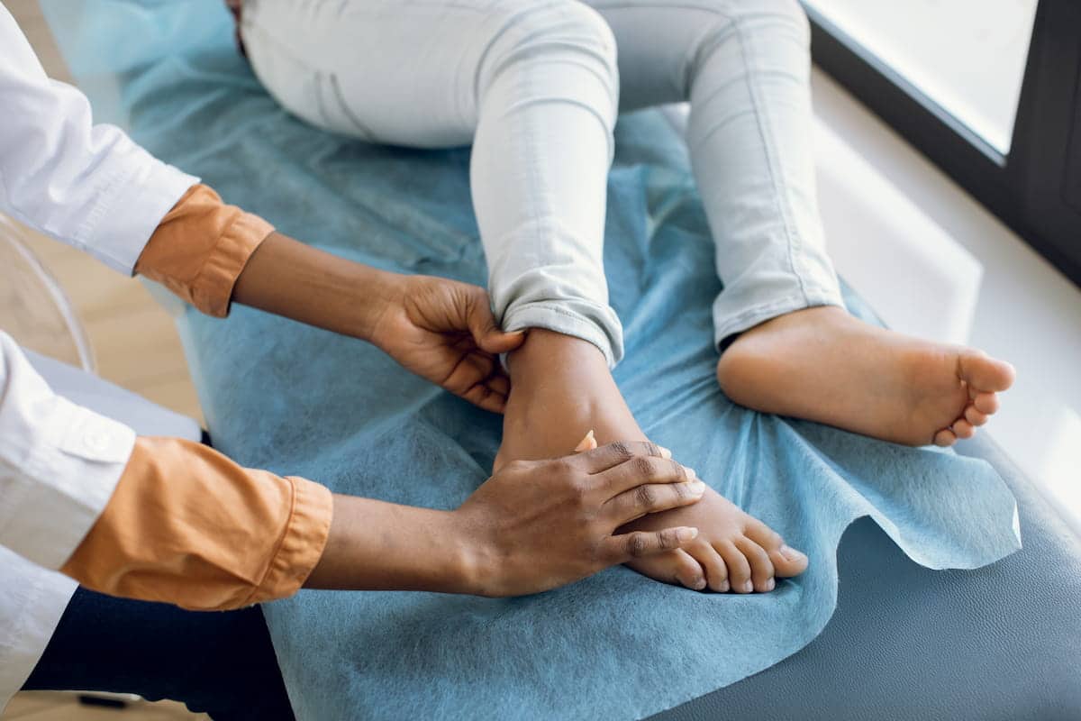 Surgeon examining a patients foot and getting ready for an orthopedic surgery.