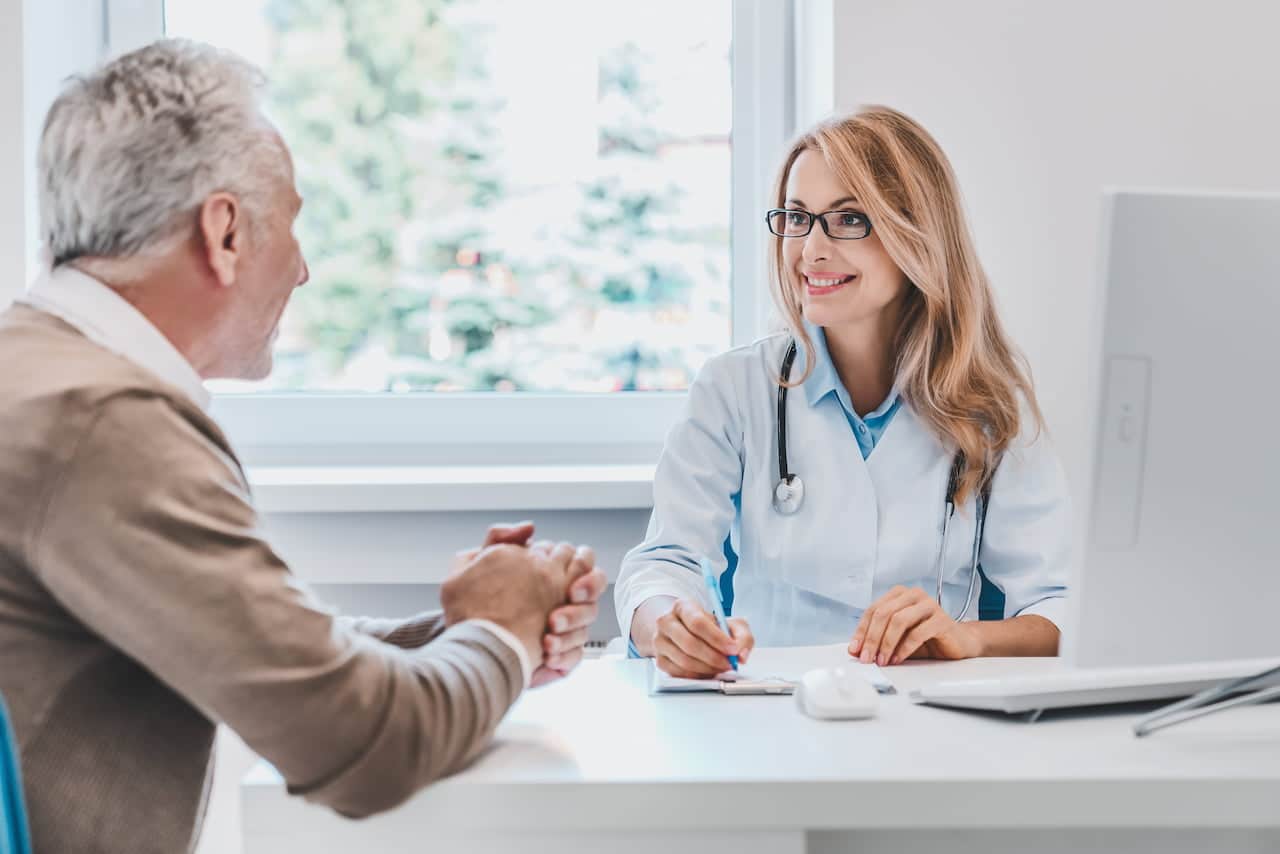 Doctor and patient sitting and talking about the medical check up.