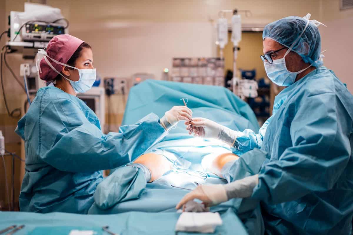 Surgeons having a foot surgery inside the operating room.