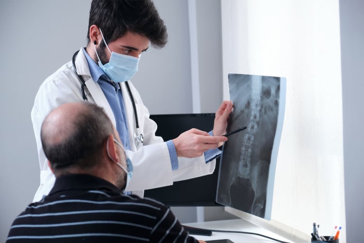 Spine surgeon explaining the xray results to the patient.