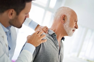 Elderly man getting his diagnosis from a doctor about his Shoulder arthritis