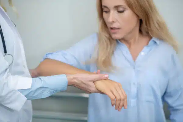 Woman consulting a physician about getting an elbow surgery